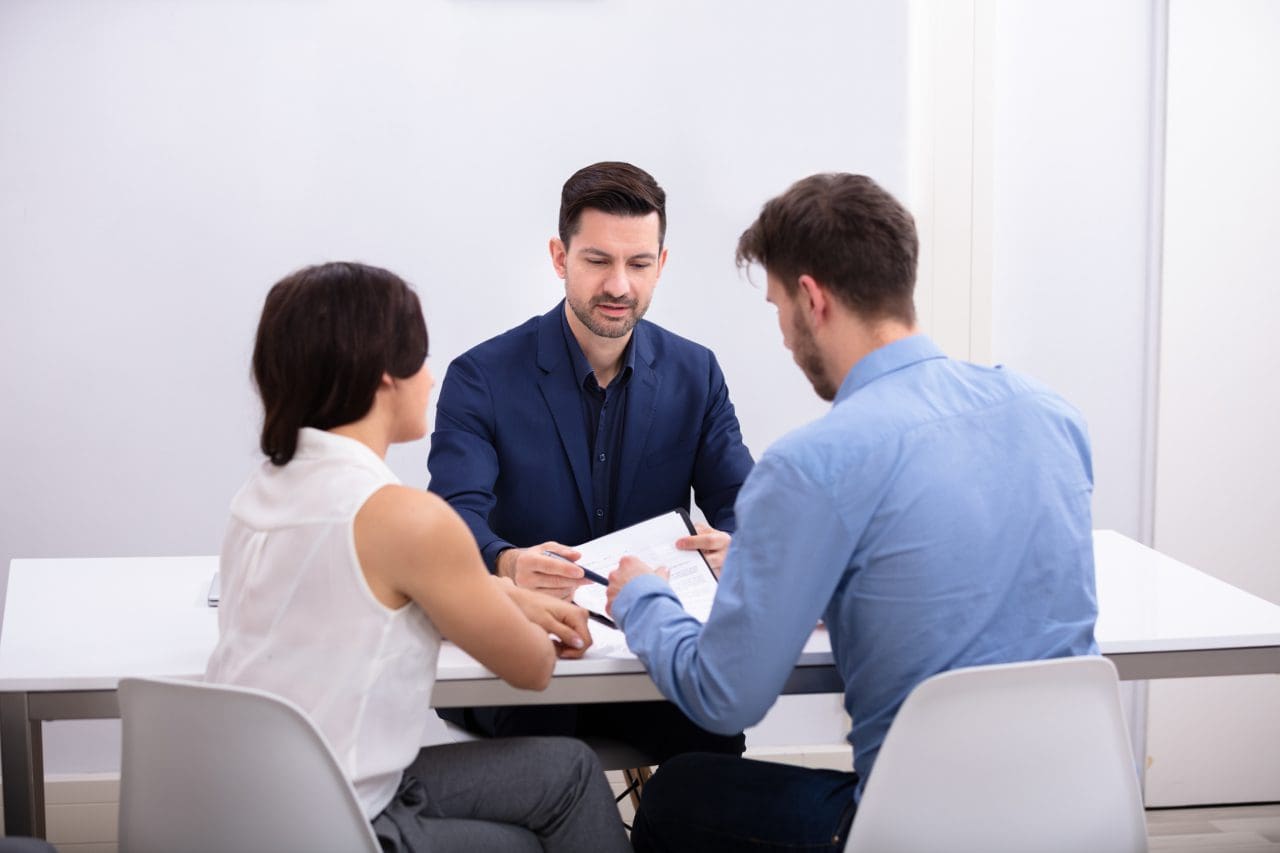 A group of people sitting around a table.